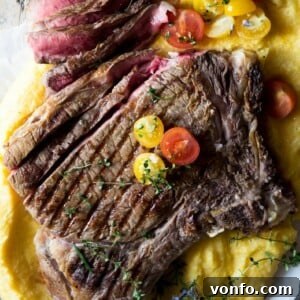 A close-up shot of a perfectly cooked Florentine steak, showing its charred exterior and juicy, rare interior when sliced.