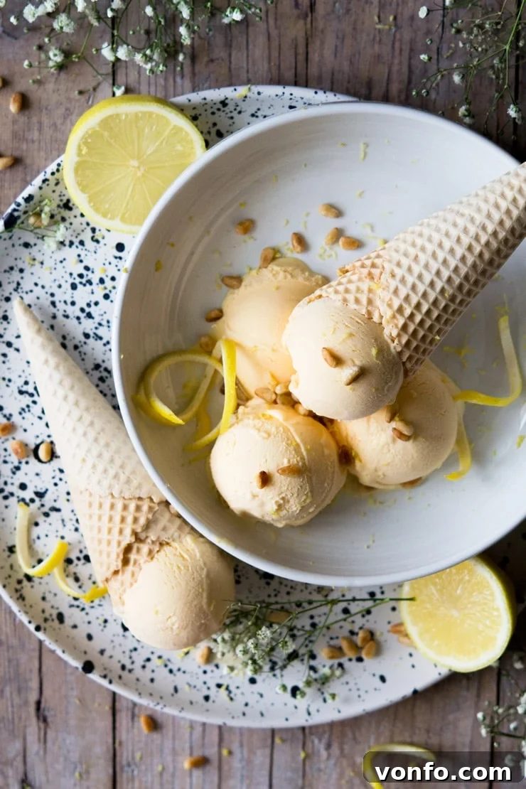 Amalfi Lemon Limoncello Gelato 2 Scoops of heavenly homemade Italian Lemon Ice Cream in a elegant bowl, garnished with delicate lemon zest spirals, inviting a taste of summer refreshment.