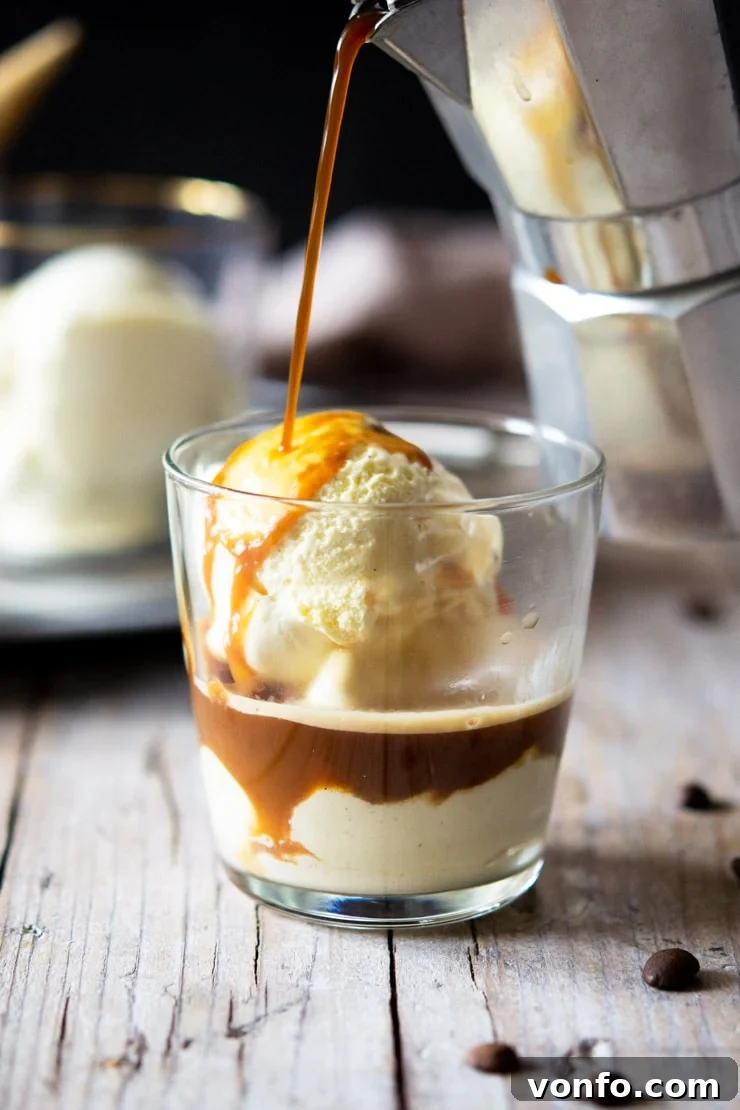 A photo of coffee getting poured over ice cream in a glass, creating an Italian Affogato
