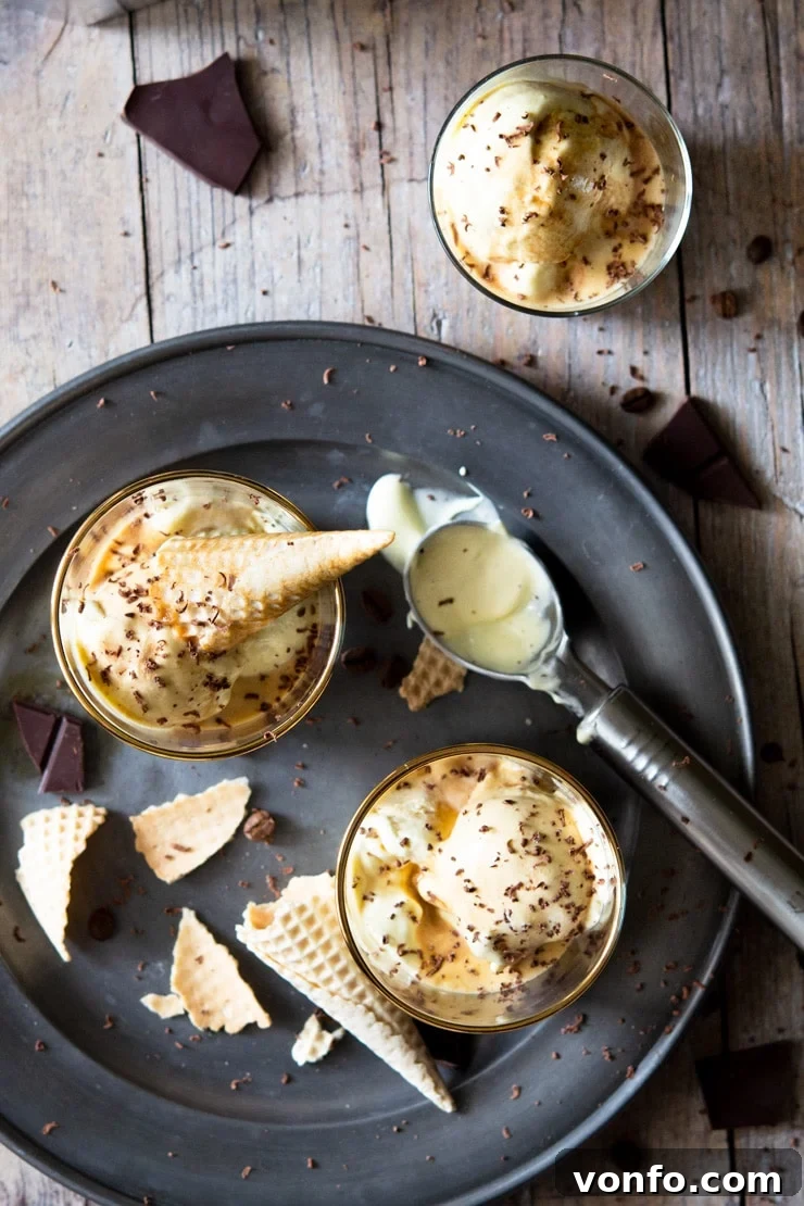 An overhead shot of two affogato desserts in glasses with ice cream cones broken up around them, ready to be enjoyed