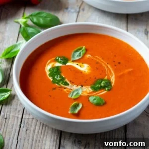 Roasted Red Pepper Soup: A Velvety Healthy Delight 2 A bowl of roasted red pepper soup with toppings