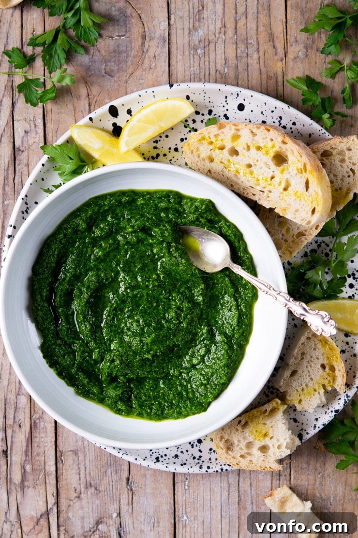 Bright and Simple Parsley Pesto 2 A bowl of fresh, green parsley pesto with a spoon, ready to serve