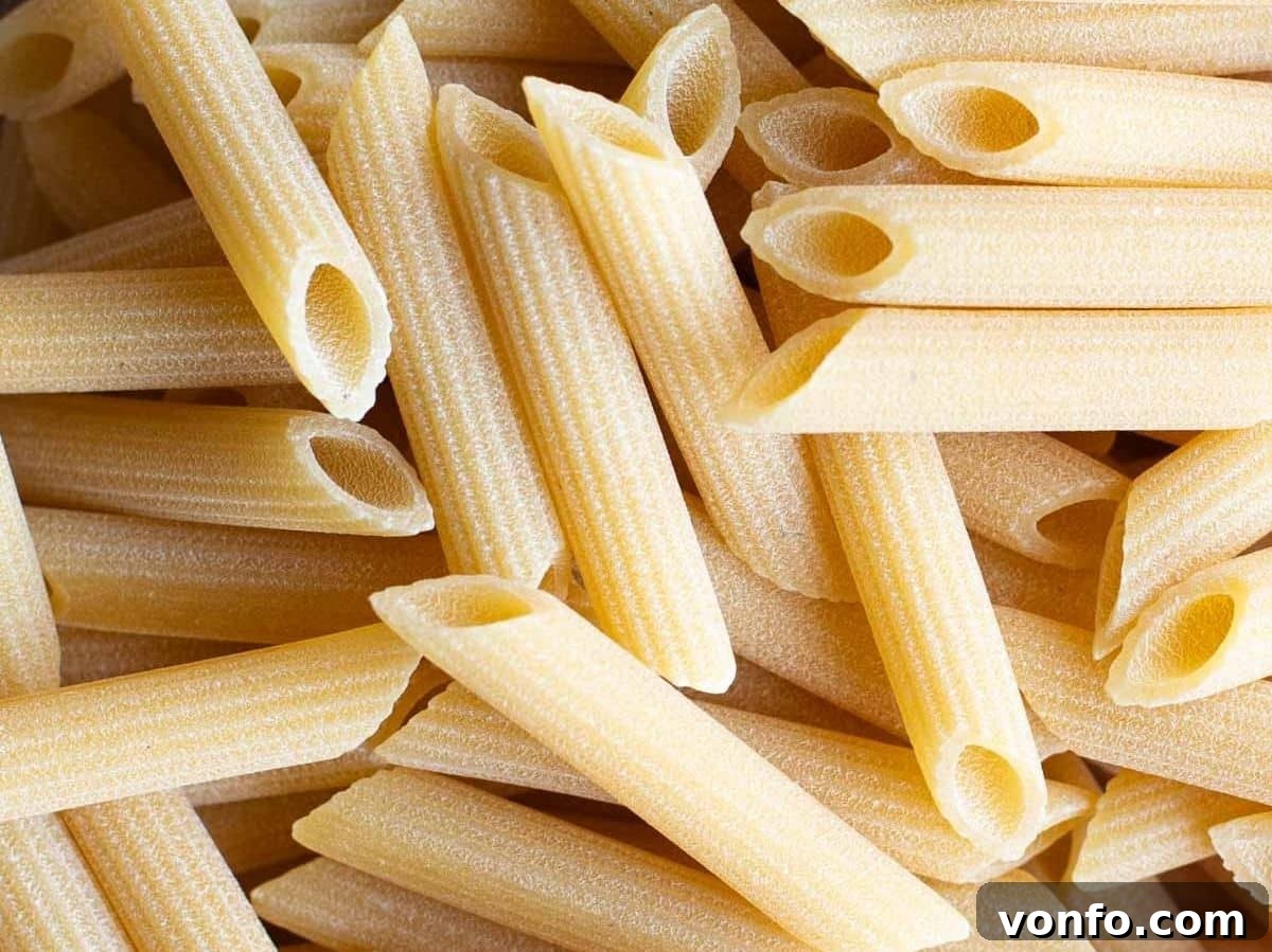 Unlocking Italian Flavors 4 A close up of penne pasta, highlighting its texture and golden hue.