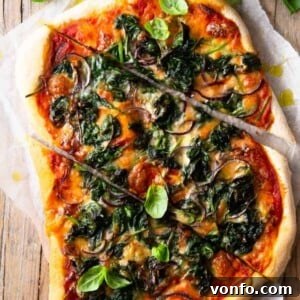 Gorgonzola, Red Onion, and Spinach Pizza 2 A beautifully baked Spinach Pizza with Gorgonzola and Red Onion, showcasing its golden crust and melted cheese, ready to be served.