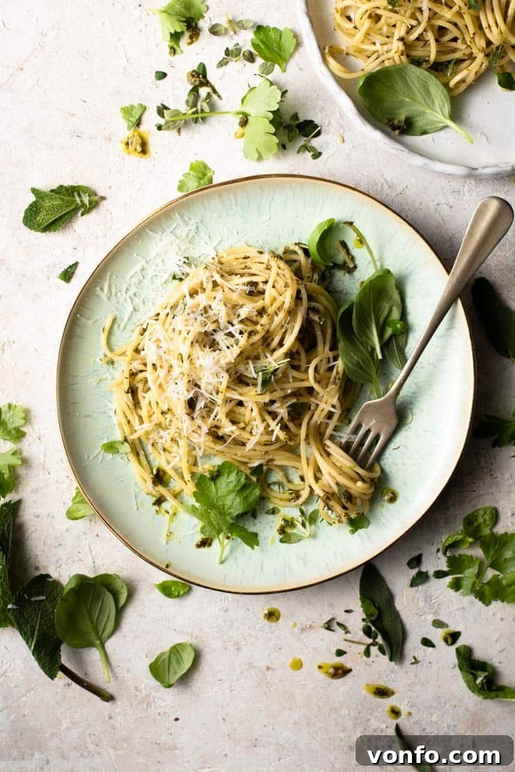 An overhead shot of spaghetti with garlic butter pasta sauce and herbs