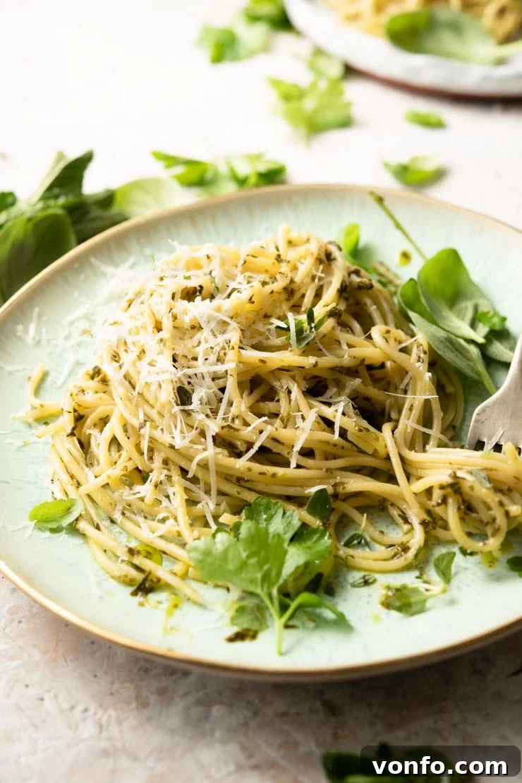 A side shot of spaghetti with garlic butter pasta sauce and herbs
