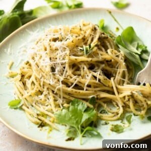 A square image of spaghetti with herby garlic butter pasta sauce