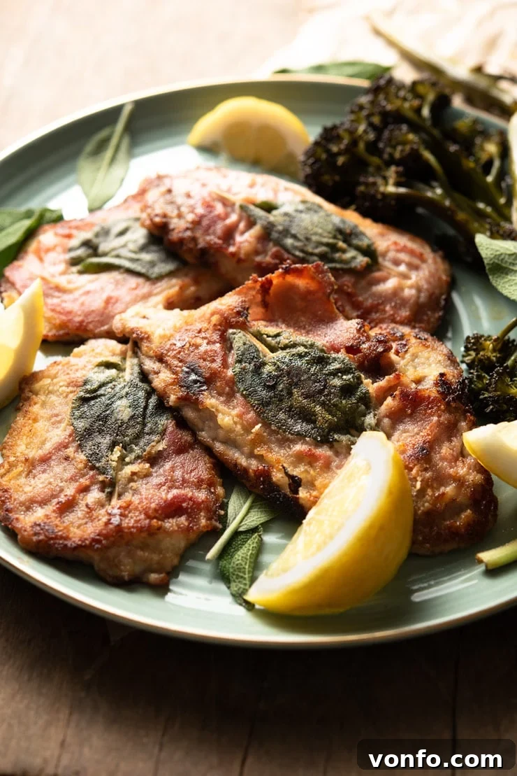 Veal Saltimbocca - a close-up of the dish, showing the perfectly cooked veal, prosciutto, sage, and lemon garnish. A side shot of a plated Veal Saltimbocca with crispy prosciutto and fresh sage, accompanied by bright lemon wedges, ready for enjoyment.