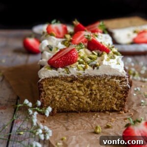 A square image of the completed Pistachio Cake with Strawberries & Cream
