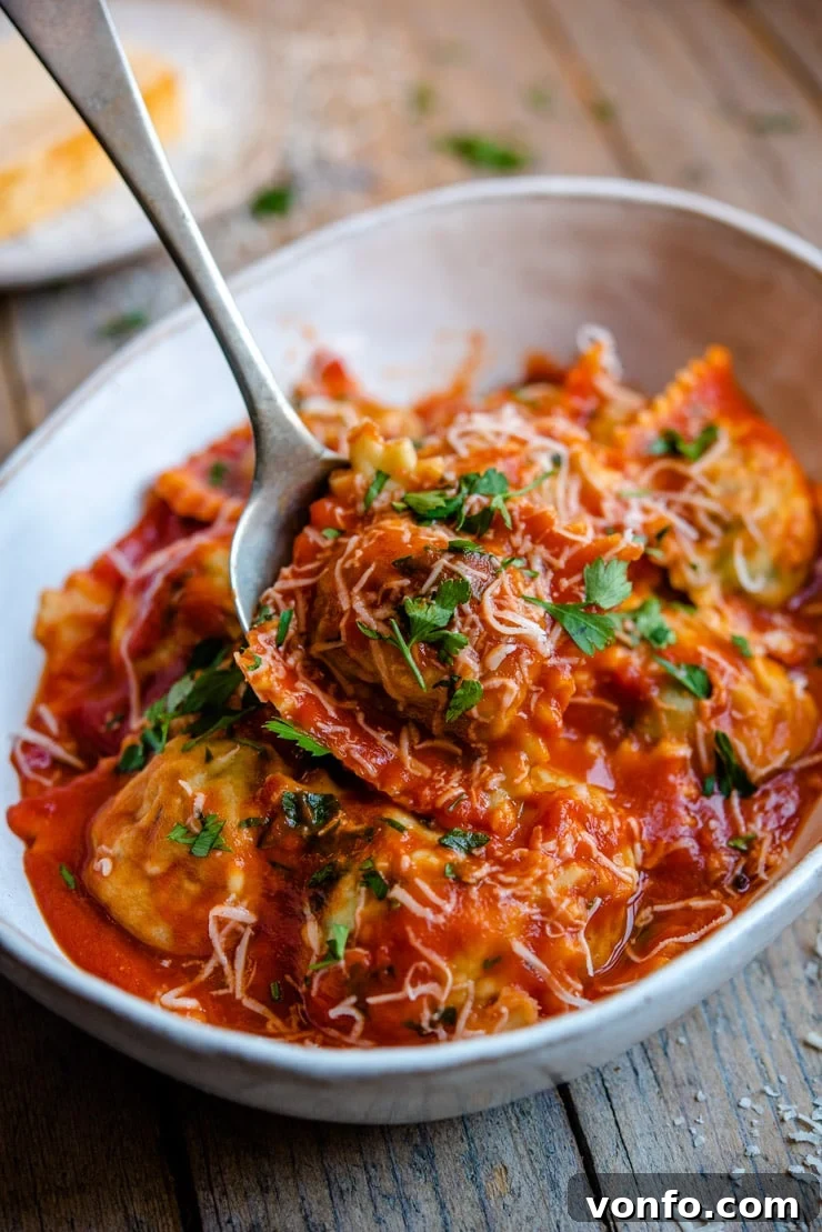 Serving homemade ravioli with a perfectly balanced sauce. Delicious homemade ravioli gently tossed with a vibrant tomato sauce in a rustic bowl, garnished with fresh herbs.