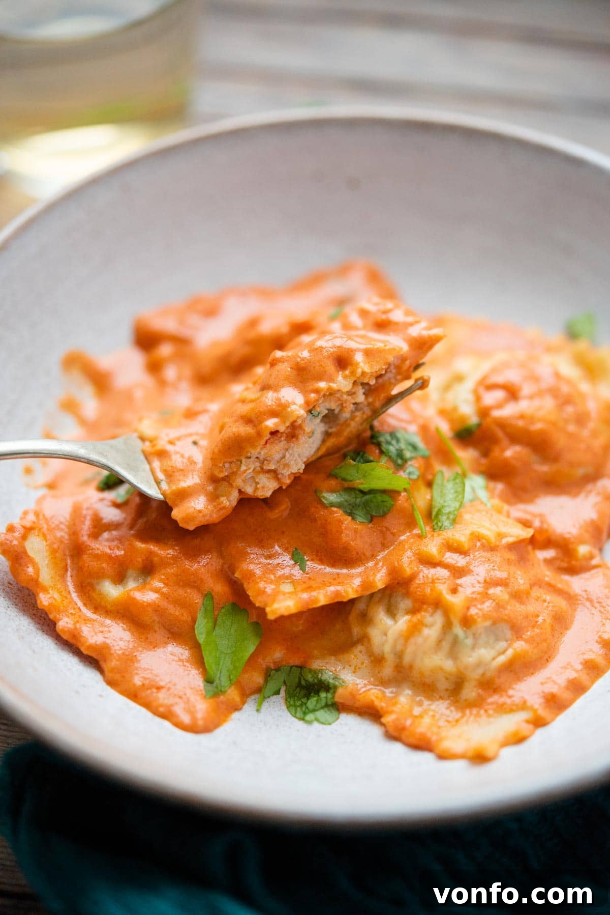 Lobster Ravioli Close-Up A close-up shot of a single lobster ravioli cut in half on a fork, revealing its delicious filling.
