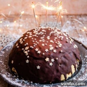 A festive Panettone Bombe, a beautiful Christmas ice cream cake adorned with sparklers, ready to be served.