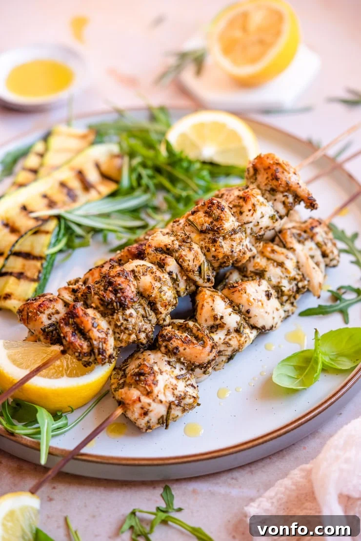 A side shot of three perfectly cooked Chicken Spiedini stacked on top of each other, highlighting their golden-brown exterior and juicy texture.