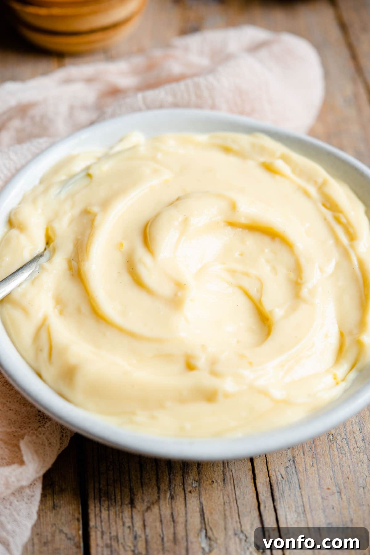 Crema Pasticcera Authentic Italian Pastry Cream 8 A close up of Italian pastry cream in a bowl, showcasing its smooth texture.