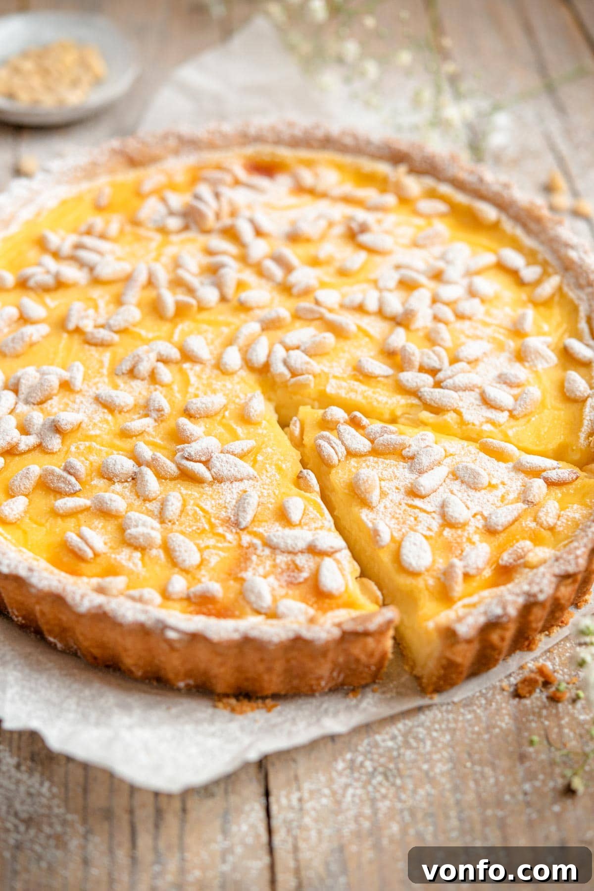 Torta della Nonna Italian Golden Custard Tart 13 A side shot of an Italian custard tart with a slice cut out