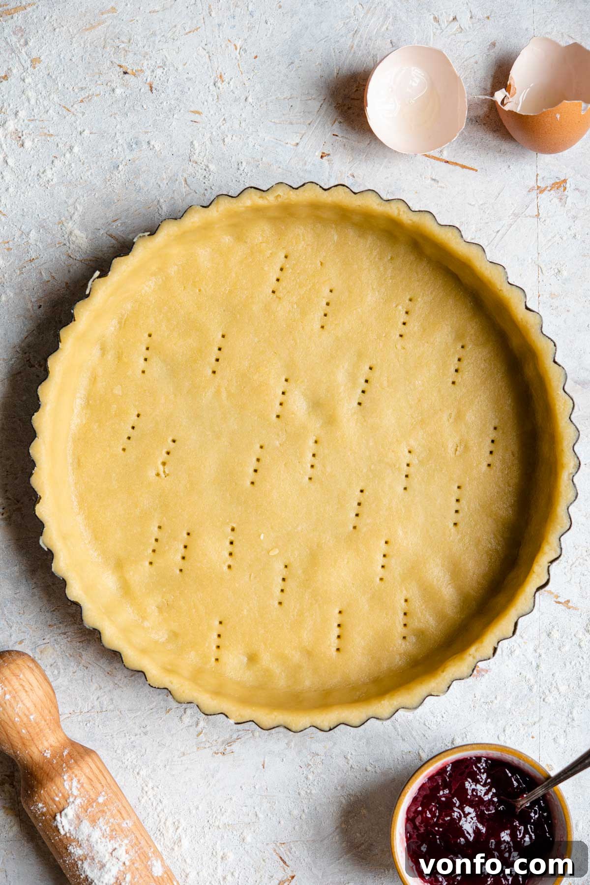 Traditional Italian Sweet Shortcrust Pasta Frolla 2 An overhead shot of raw sweet shortcrust pastry in a pie case, ready for filling and baking.