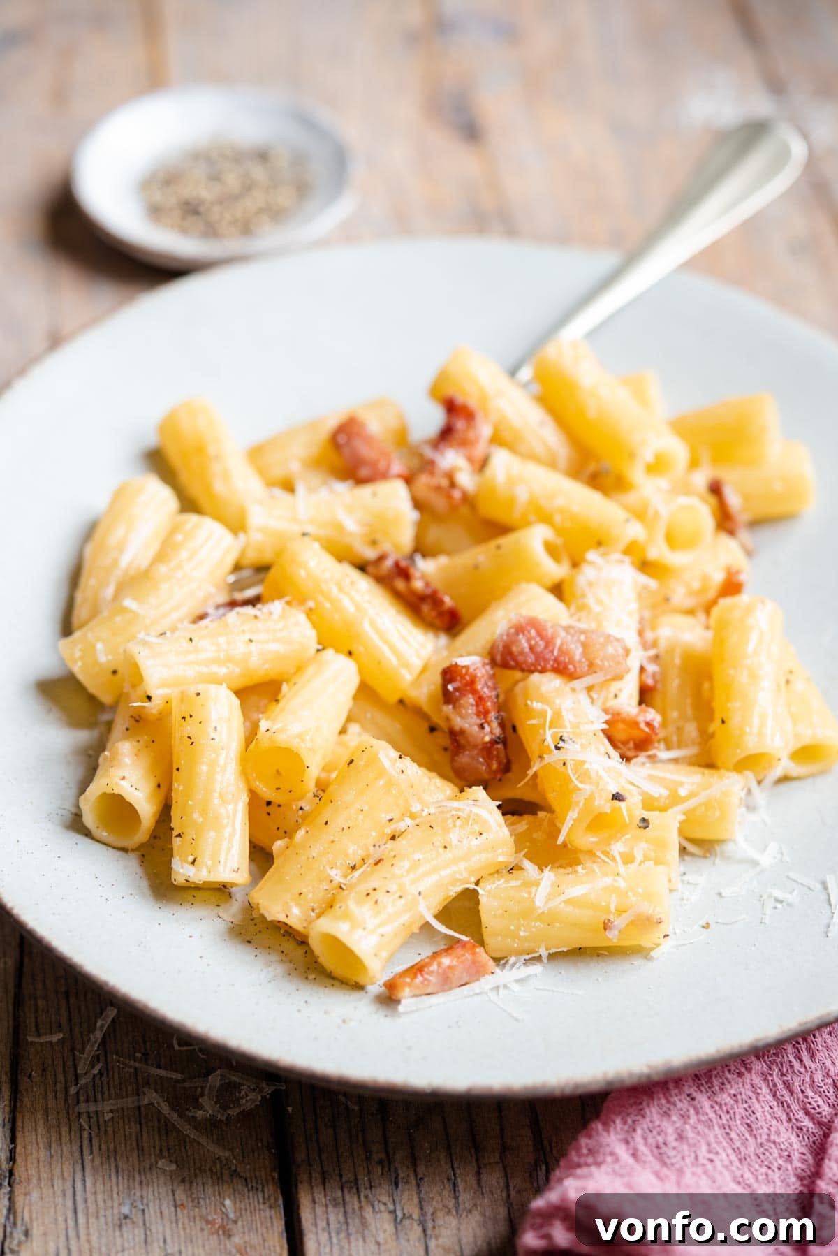 Classic Gricia Pasta 6 A side shot of a perfectly plated portion of Pasta alla Gricia, featuring rigatoni pasta glistening with creamy sauce and golden crispy guanciale, ready to be enjoyed.