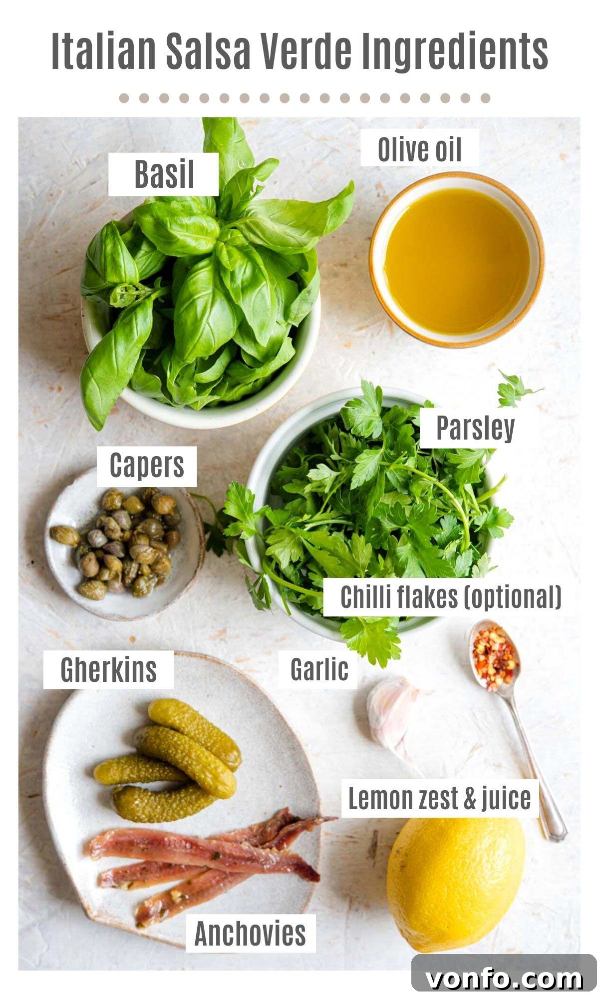 Vibrant Italian Salsa Verde 3 An overhead shot of all the fresh ingredients needed for Italian Salsa Verde laid out: vibrant basil, parsley, garlic, briny capers, gherkins, anchovies, a lemon, a bottle of olive oil, and a sprinkle of chilli flakes.