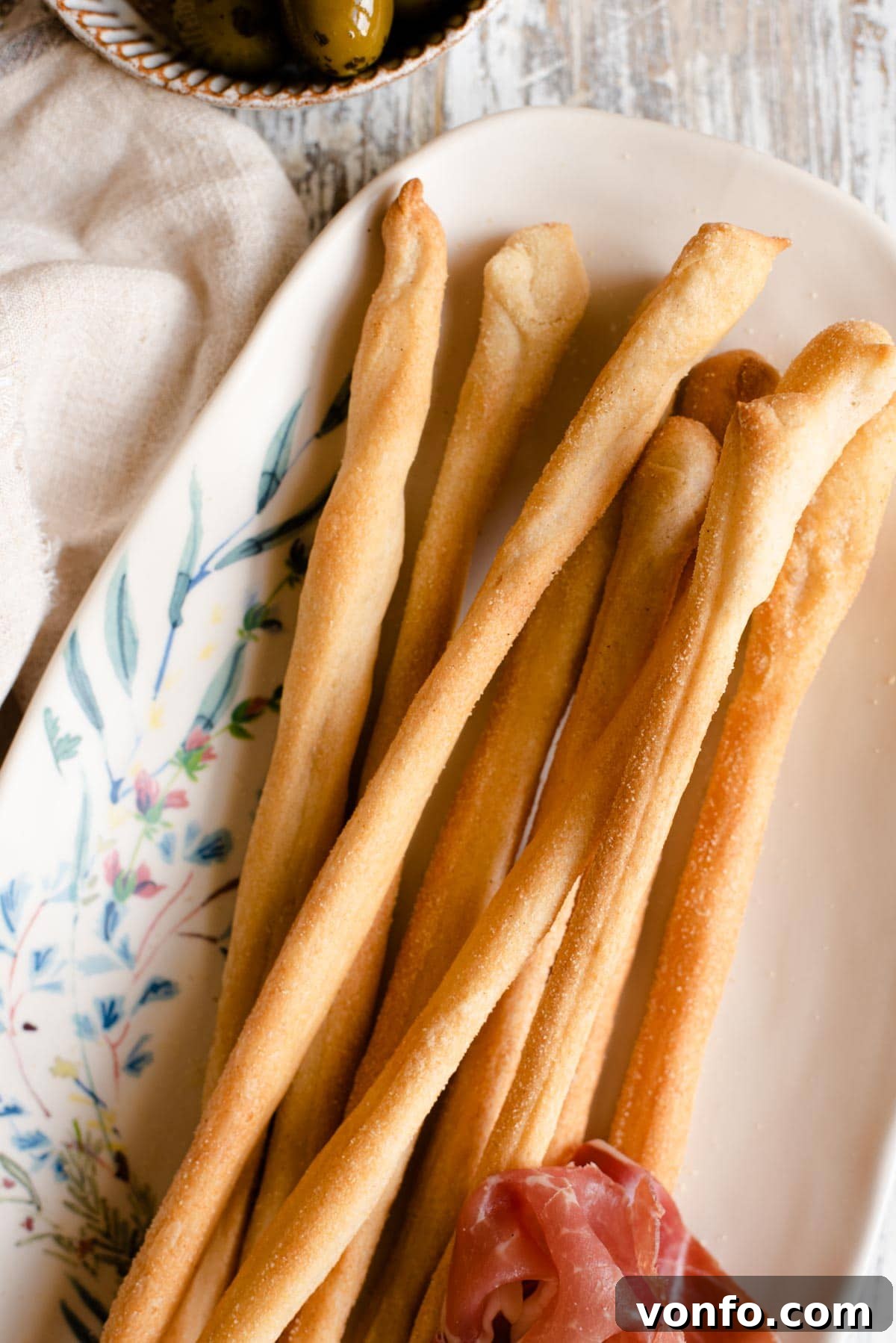 Grissini: Italy's Iconic Breadsticks 8 A close up of Italian Grissini breadsticks on a serving plate