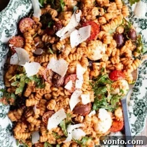 Sun-Dried Tomato Pasta Fredda: Chilled Mediterranean Pasta Salad 9 A close up of sun-dried tomato pasta fredda on a serving plate.