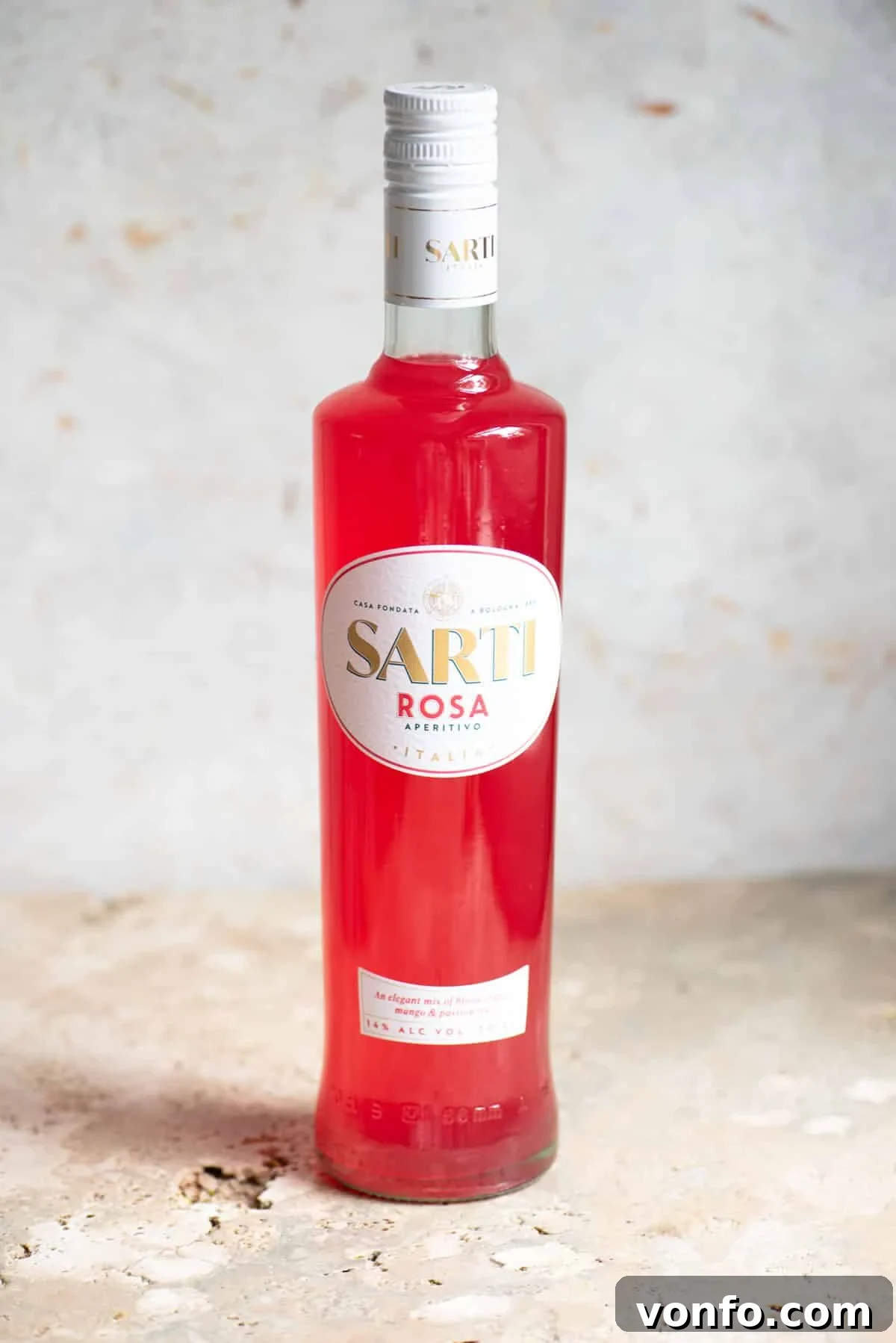 A bottle of Sarti liqueur on a neutral background.