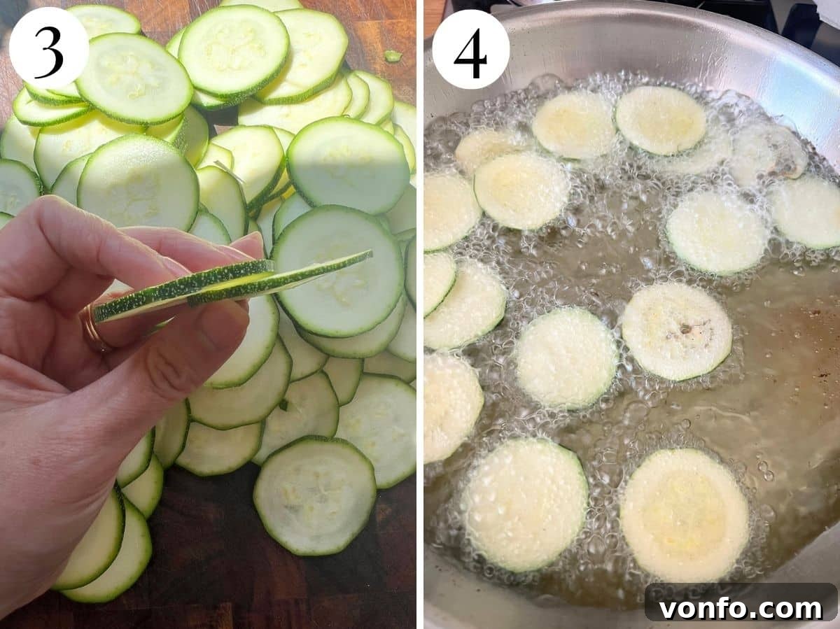 Thinly sliced zucchini and it frying in a pan of hot oil.