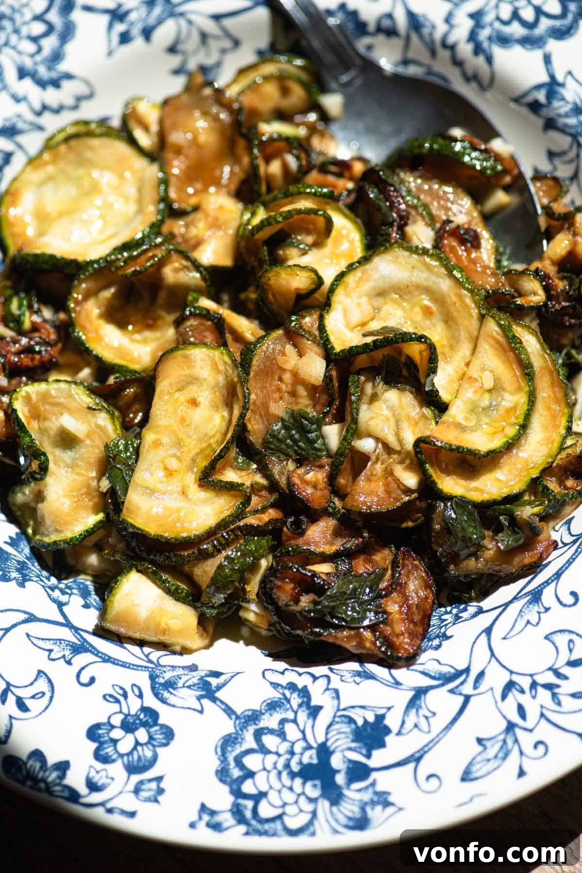 Neapolitan Zucchine alla Scapece: Fried Marinated Zucchini 4 A close up of fried marinated zucchini in a blue bowl.