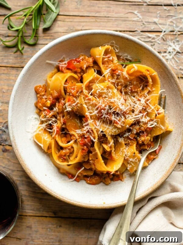 Slow-Braised Eggplant and Sausage Ragu 7 An overhead shot of a bowl of pasta on a wooden surface