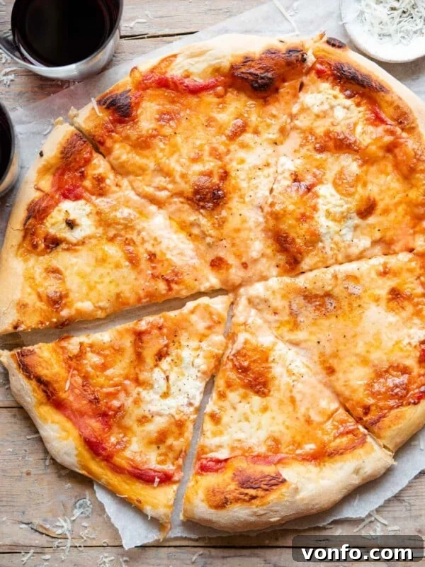 Mediterranean Pizza with Olives, Anchovies & Capers 5 An overhead shot of a four cheese pizza cut into slices