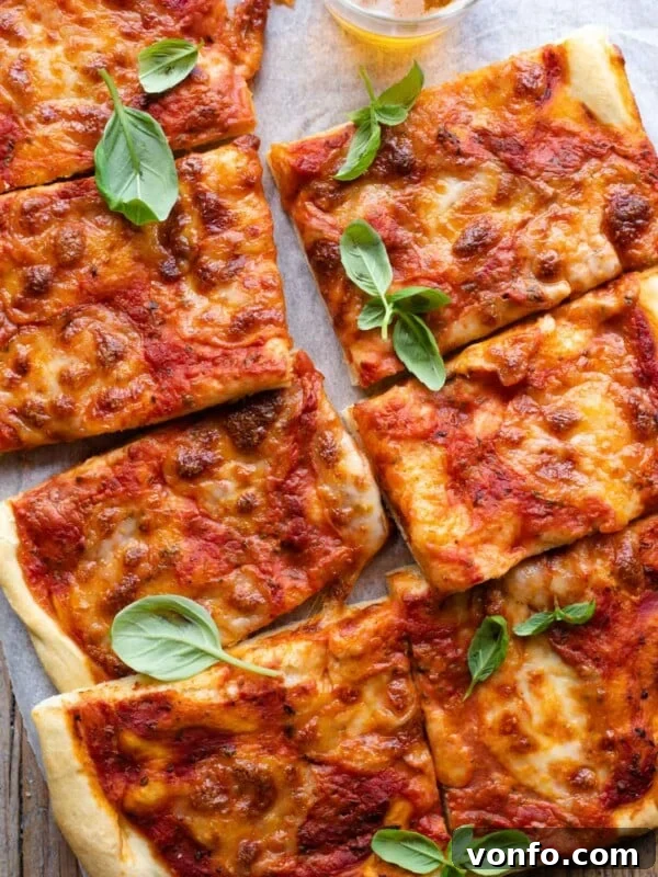 Mediterranean Pizza with Olives, Anchovies & Capers 6 An overgead shot of a focaccia pizza cut into slices