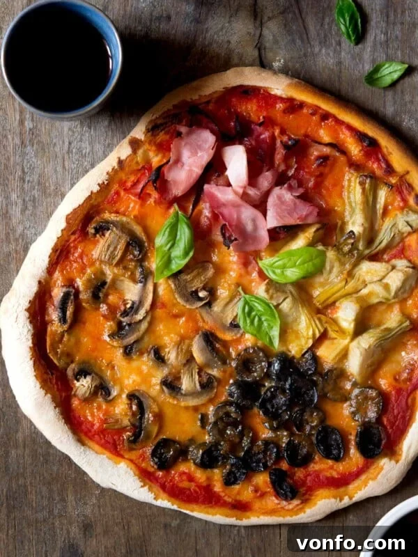 Mediterranean Pizza with Olives, Anchovies & Capers 8 AN overhead shot of a four seasons pizza