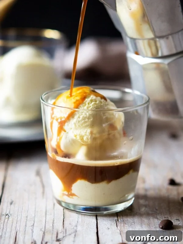 A photo of coffee getting poured over ice cream in a glass to make an affogato