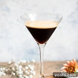 A close up of a cocktail glass filled with an iced coffee.