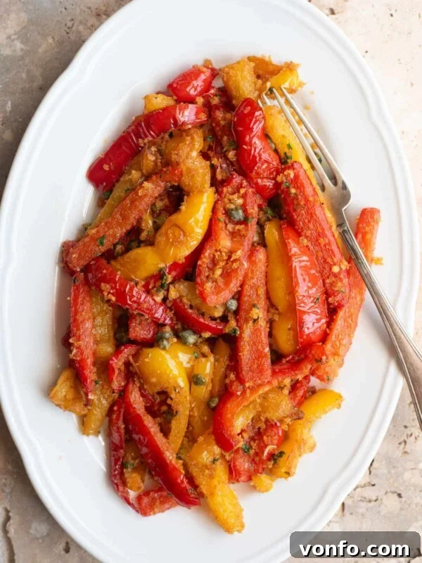 An overhead shot of Peperoni Ammollicati (Italian peppers and breadcrumbs) on a white serving plate.