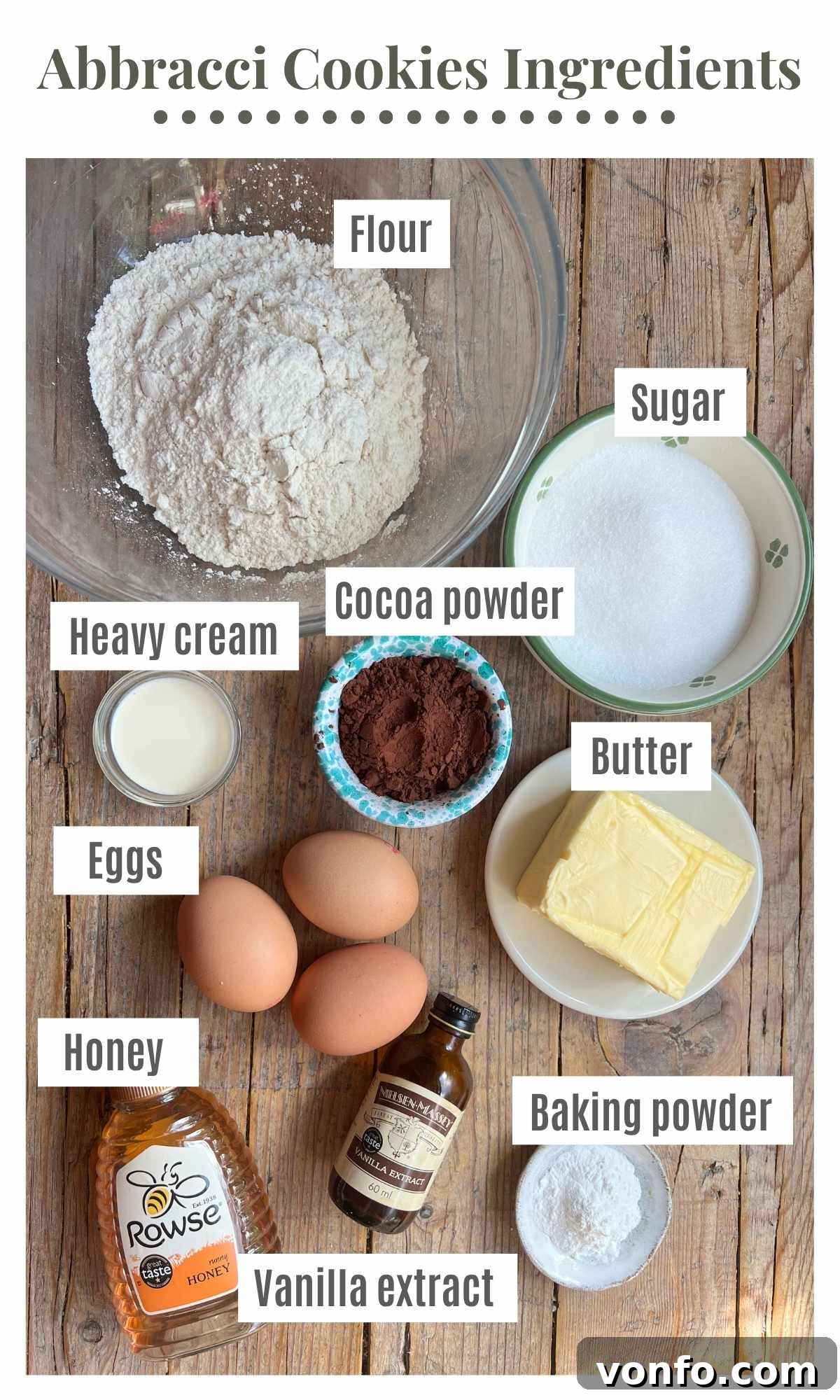 An overhead shot showing all the ingredients to make abbracci cookies laying on a rustic wooden surface.
