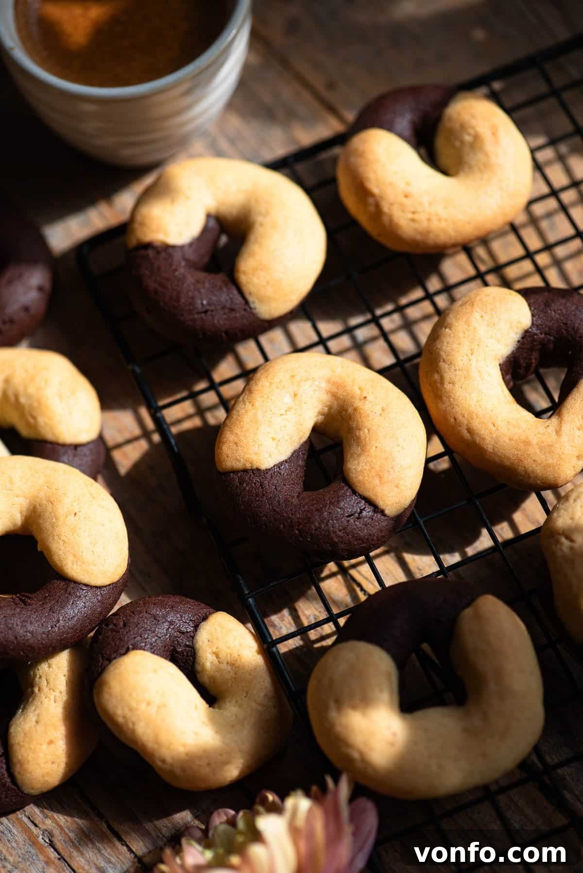A close up of Italian abbracci cookies (chocolate and cream) on a cooling rack.