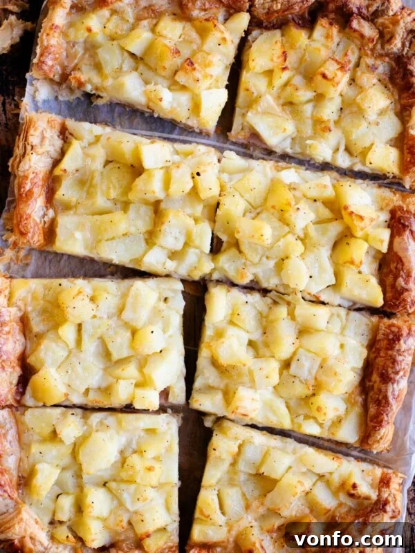 Danubio Salato: Neapolitan Savory Stuffed Brioche Buns 6 An overhead shot of a puff pastry tart topped with potatoes, ham and cheese and cut into 8 slices.