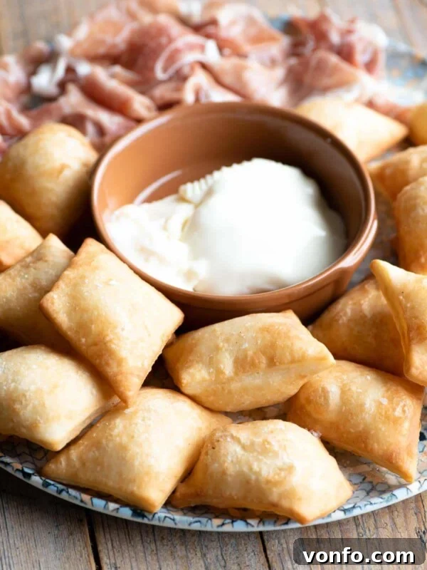 Danubio Salato: Neapolitan Savory Stuffed Brioche Buns 8 Gnocco Fritto (Italian fried dough) on a plate with cheese and prosciutto.